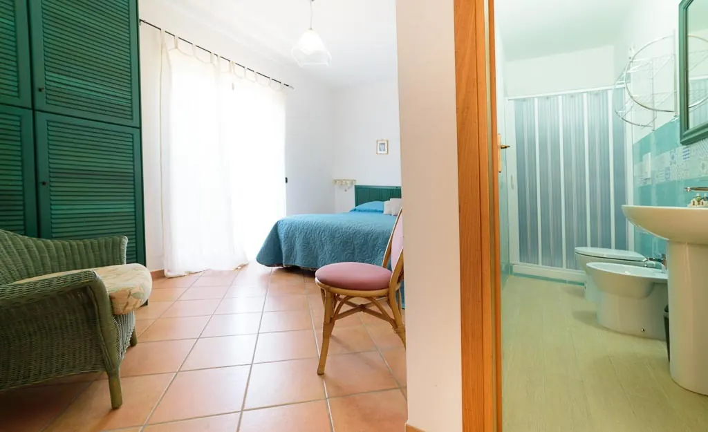 En-suite bedroom: double room at Villa MaLuGio with private bathroom and terracotta floor, Casal Velino Cilento