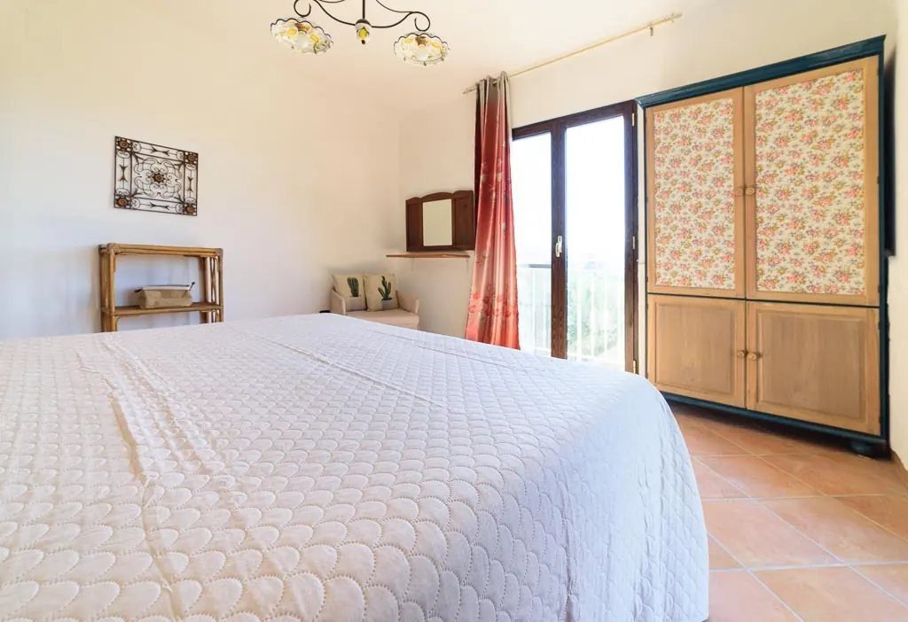 Bright floral bedroom: double room at Villa MaLuGio with floral wardrobe, balcony and terracotta floor, Casal Velino Cilento