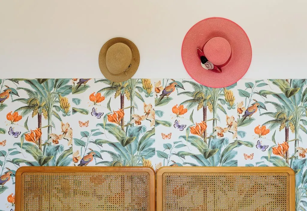 Botanical details: tropical wallpaper with birds and decorative straw hats in Villa MaLuGio bedrooms, Cilento